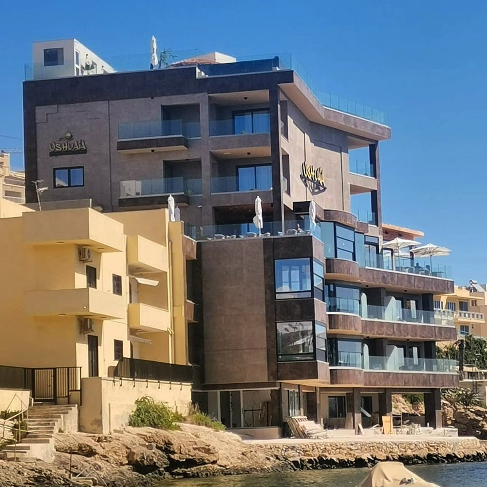 A modern apartment block on a dry hillside