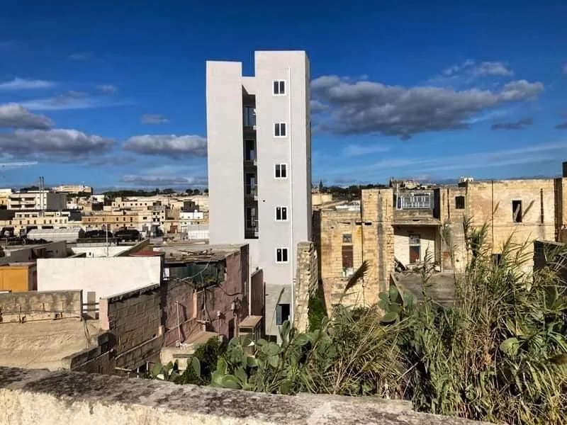 Apartment blocks beside older ruins